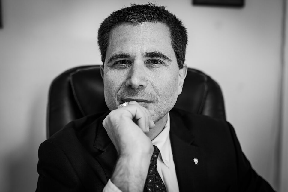 Black and white executive portrait at a desk