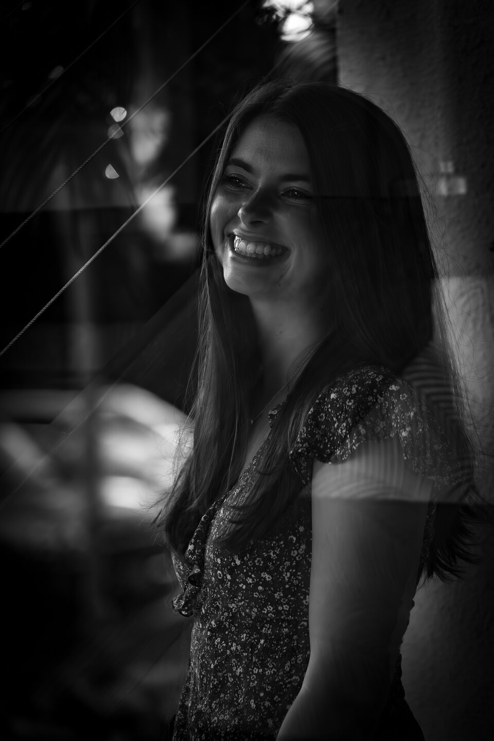Black and white portrait seen through a window reflection