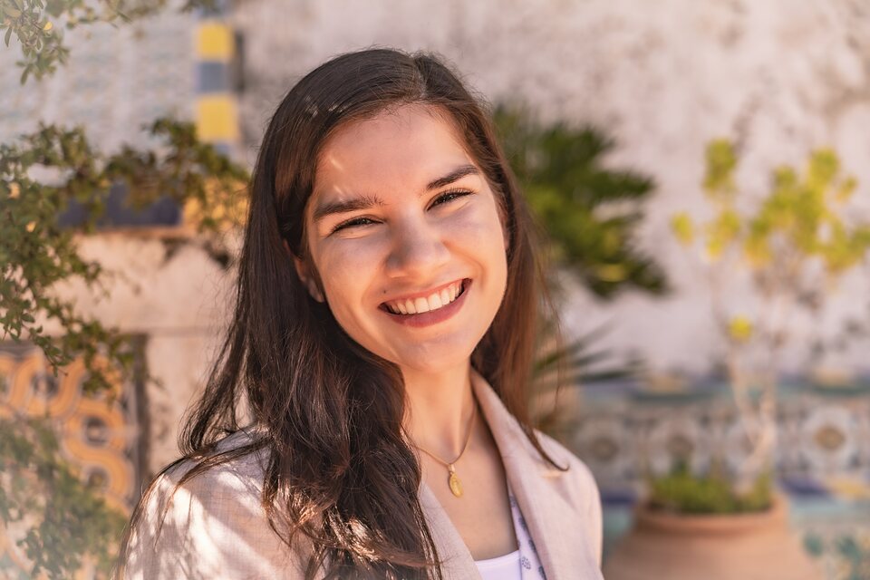 Portrait in low golden light beside a patterned tile wall